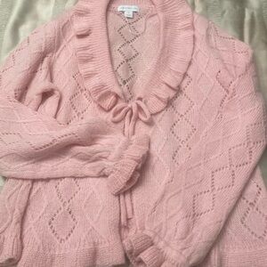 Pink, tie in front, ruffled neck and sleeves,sweater.